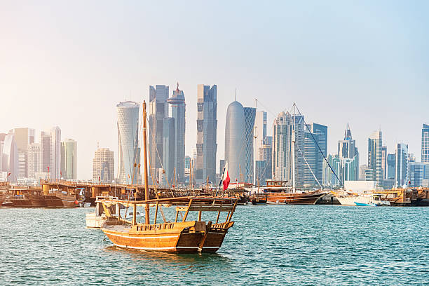 Traditional Dhows in Front of Modern Doha Skyline, Qatar Traditional Dhows in the harbor in front of Doha Skyscraper Skyline. Doha, Qatar, Middle East.  dhow photos stock pictures, royalty-free photos & images