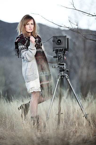 istock Young Woman with Vintage Bellow Camera 459292753