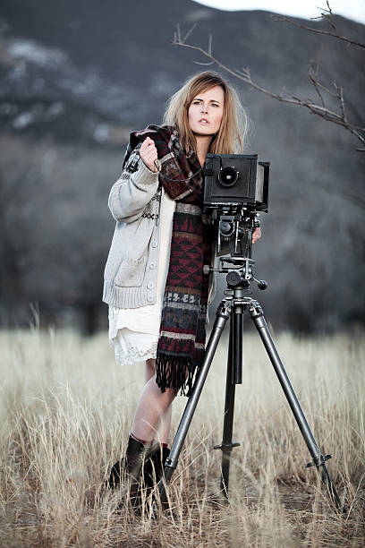 istock Young Woman with Vintage Bellow Camera 459292757