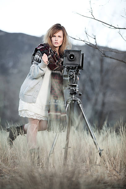 istock Young Woman with Vintage Bellow Camera 459292827