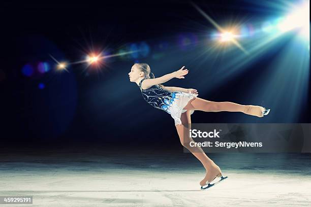 Young Girl Figure Skating With Spotlight On Her Stock Photo - Download Image Now - Figure Skating, Sport, Child