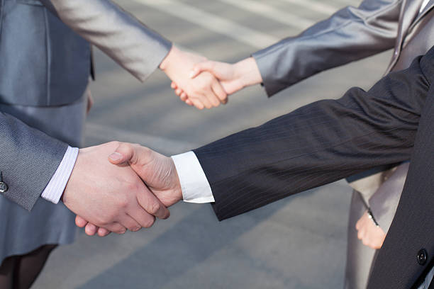 istock Close up of four business people shaking hands 459300191