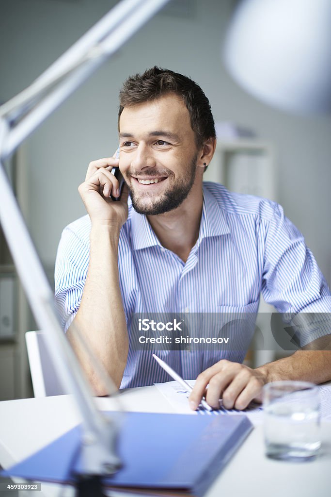 Hello? Elegant businessman speaking on the phone Adult Stock Photo