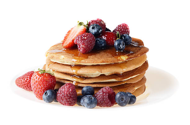 istock Pancakes with berries and honey over white 459315073