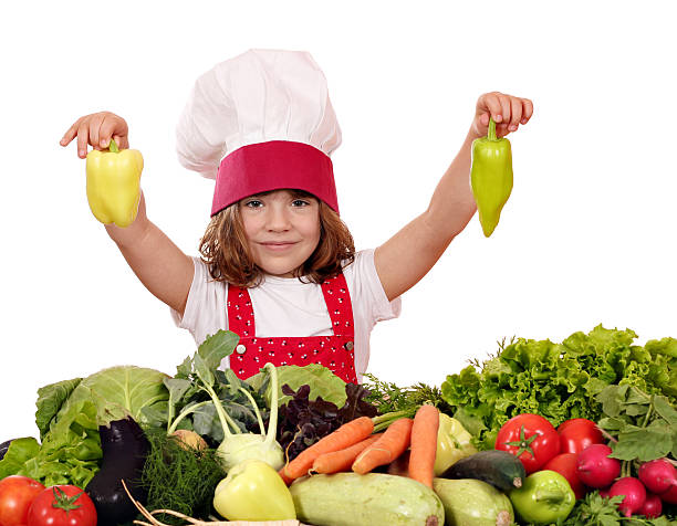 istock little girl cook holding peppers 459316527