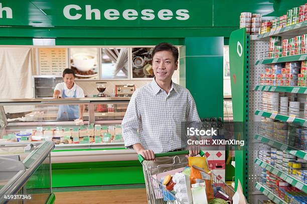 Man Shopping In Supermarket Pushing Cart Beijing Stock Photo - Download Image Now - Pushing, Shopping Cart, 30-34 Years