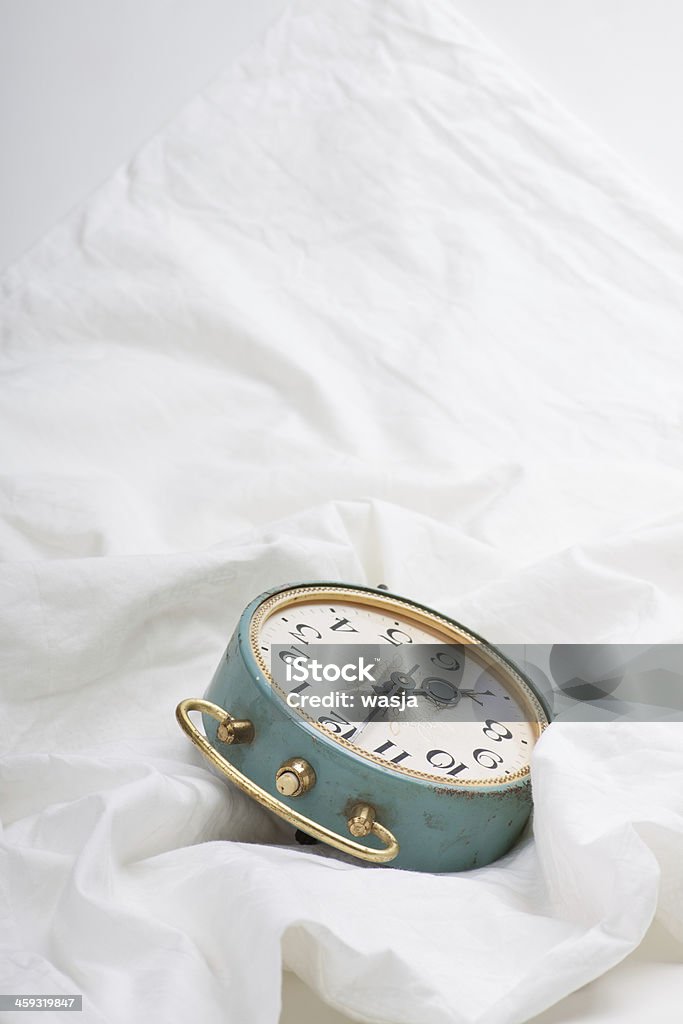 Alarm clock on the bed Alarm Clock Stock Photo