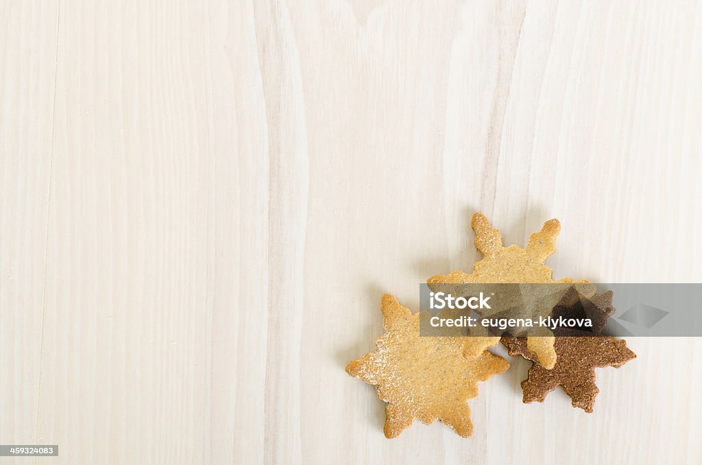 snowflake christmas cookies as a background snowflake decorated christmas cookies on light wooden background Baked Stock Photo