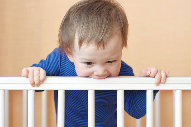 istock baby age 1 year gnaws white bed 459325581
