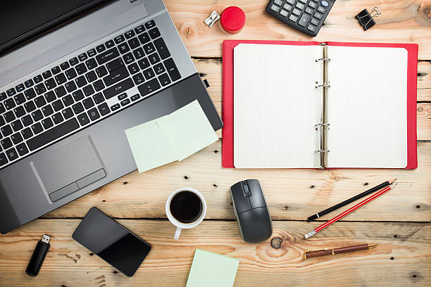 istock Workplace, laptop and notepad on wooden table 459327305