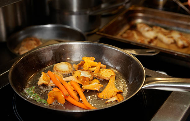istock Potatoes, carrots and mushrooms being fried in pan 459329825