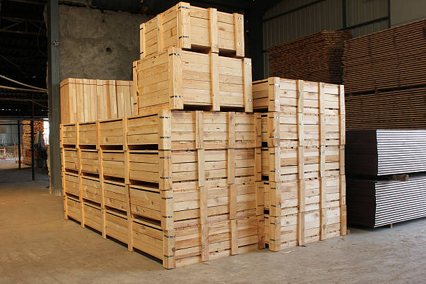 istock Wooden cases stacked high at a warehouse 459334475