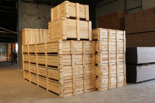 Wooden cases stacked high at a warehouse