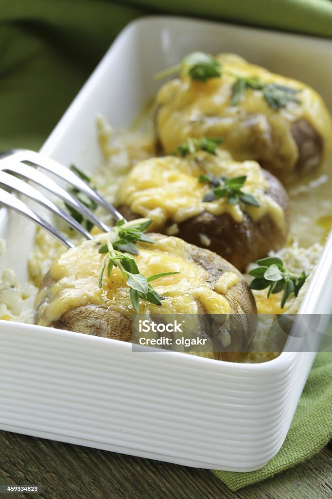 mushrooms baked with cheese mushrooms baked with cheese, thyme served  on a wooden table Appetizer Stock Photo