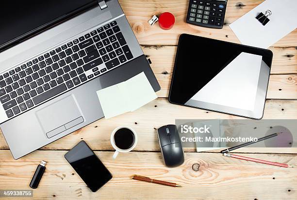 View Of A Workplace With Laptop And Tablet On Wooden Table Stock Photo - Download Image Now