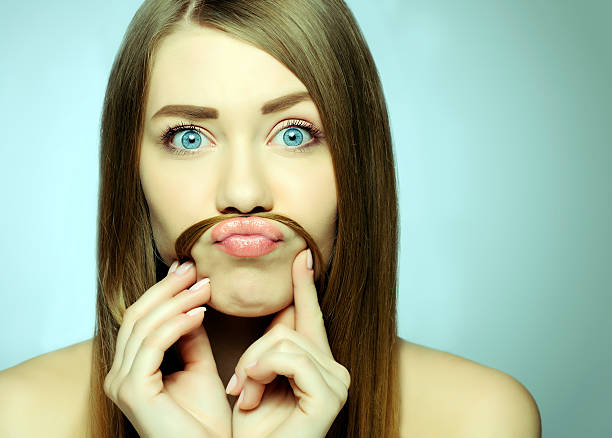 movember look funny woman with hair moustache grimacing. women movember mustache facial hair stock pictures, royalty-free photos & images