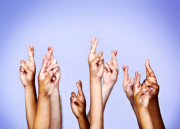 istock Nine hopeful hands with fingers crossed superstitiously, just in case! 459347163