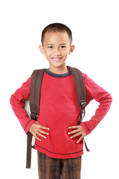 istock Portrait of boy with backpack smiling against white 459348823