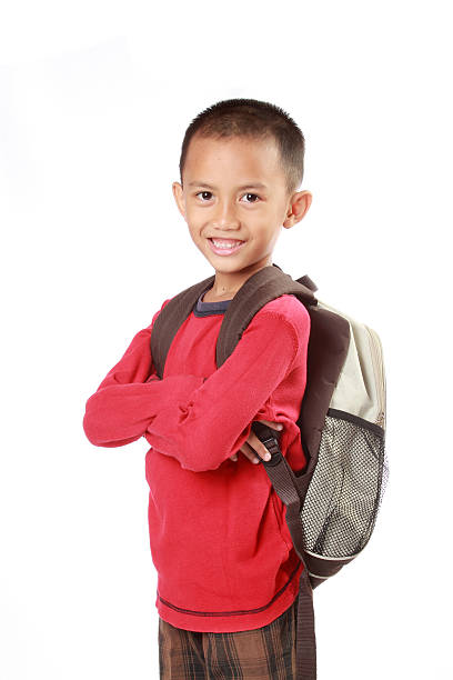 istock Portrait of boy with backpack smiling against white 459349095
