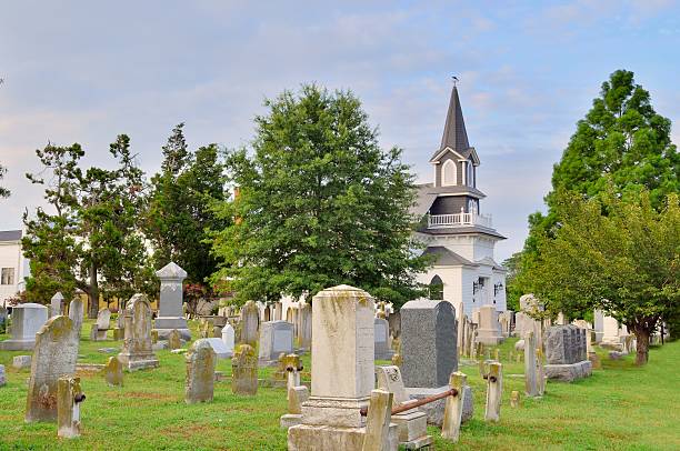 An old cemetery with a white wooden church in Lewes, Delaware. This is the Lewes Presbyterian Church for what its worth