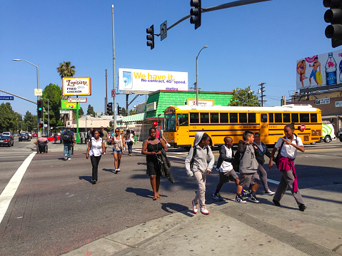 Los Angeles, USA  - May 10, 2013: People crossing street in Los Angeles Suburb