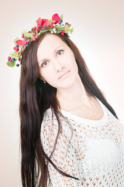 istock Young beautiful woman with flower wreath on head 459352661