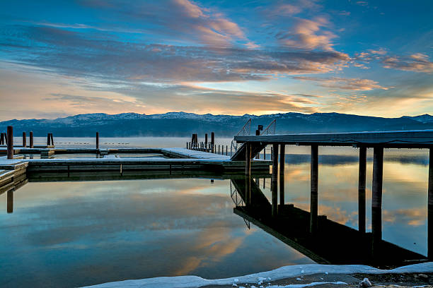 istock Winter mountain lake with boat docs covered and snow 459356795