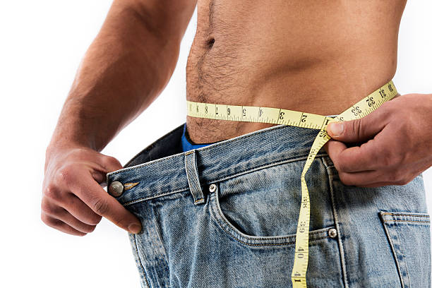 istock Man measuring waist 459356803