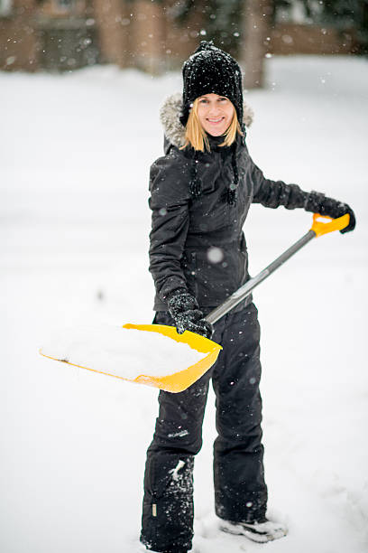 istock Shovelling snow off her driveway after a storm 459358847