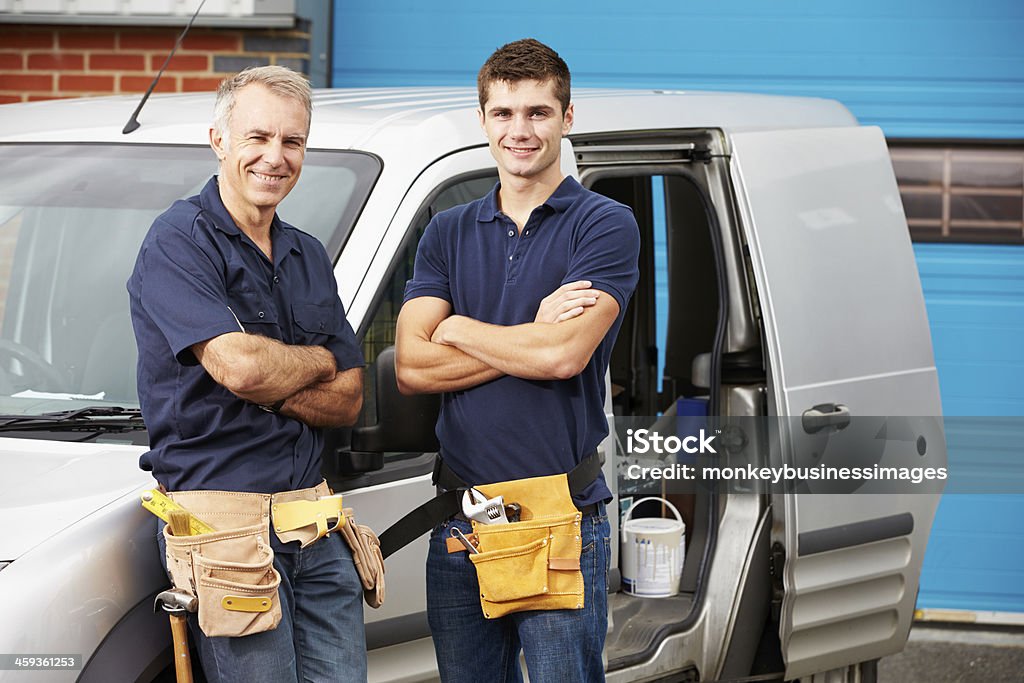 Workers In Family Business Standing Next To Van Workers In Family Business Standing Next To Van Smiling At Camera Plumber Stock Photo