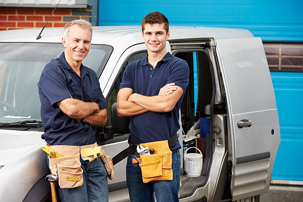 Workers In Family Business Standing Next To Van Workers In Family Business Standing Next To Van Smiling At Camera van vehicle stock pictures, royalty-free photos & images