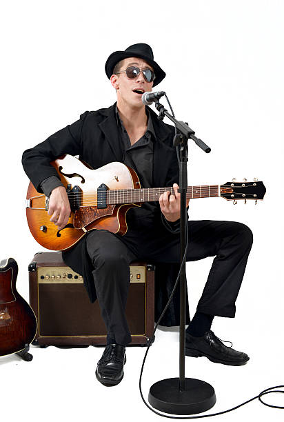 istock the guitarist sings sitting on an amplifier 459365877