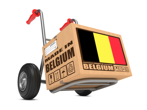 Cardboard Box with Flag of Belgium and Made in Belgium Slogan on Hand Truck White Background. Free Shipping Concept.