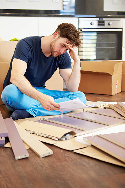 istock Frustrated Man Putting Together Self Assembly Furniture 459368899