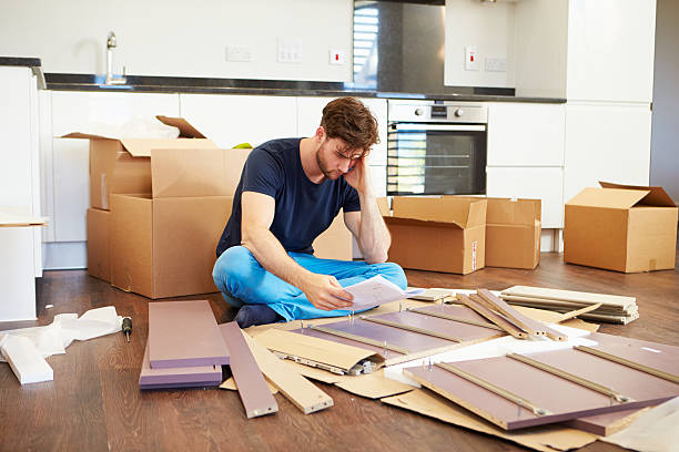 istock Frustrated Man Putting Together Self Assembly Furniture 459369841