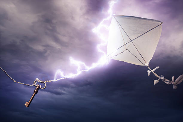Conceptual image of kite with key being stuck by lightning stock photo