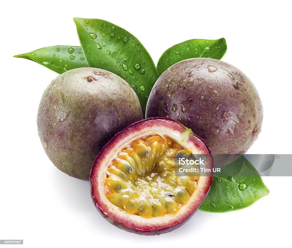 Wet passion fruits with leaves isolated on white Passion Fruit Stock Photo