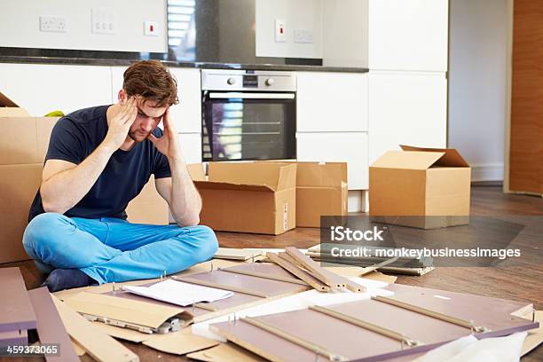 A Man Confused In Putting Together A Self Assembly Furniture Stock Photo - Download Image Now