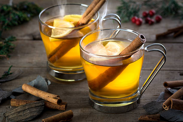 Two Hot Toddy Cocktail Drinks with Cinnamon and Lemmon stock photo