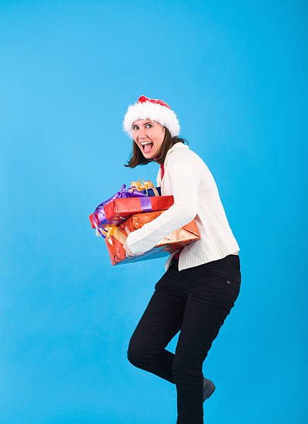 istock Happy Santa woman holding presents 459385427