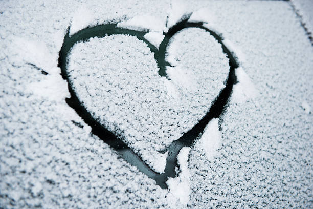 istock Heart drawn on a snow covered car window 459385591