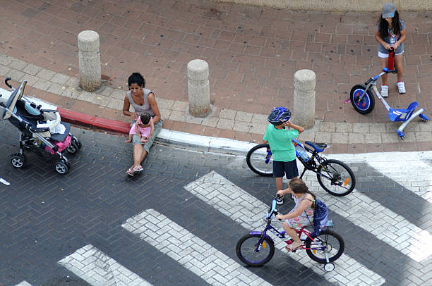 Rishon Lezion,Israel- October, 8 ,2011 Yom Kippur day at Israel, people and kids with bicycles at roads without trafic