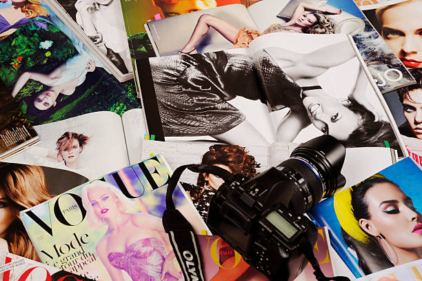 Fashion magazines Seoul, Korea - January 8, 2012:Studio product shot of fashion magazines, VOGUE, with postit marks and an OLYMPUS DSLR. vogue cover stock pictures, royalty-free photos & images