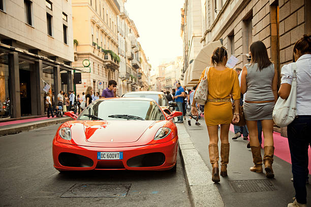 Milan, Italy - October 01, 2011: A bright Red Ferrari F430 sports car is parked in Via Monte Napoleone, the heart of Milans high-class shopping district