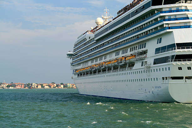 Venice, Italy - August 4, 2008: Big Passenger Ship in the Venetian Lagoon. The ship on the picture is a ship of the ocean carrier Costa. The name of the big steamer is Costa Fortuna, a sister ship of the Costa Concordia. The Costa Fortuna is a cruise ship for Costa Cruises. It was built in 2003.