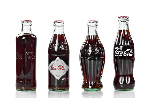 Alanya, Turkey - October 10, 2011: Four Coca-Cola bottles, an 125 years old anniversary edition, studio shot.