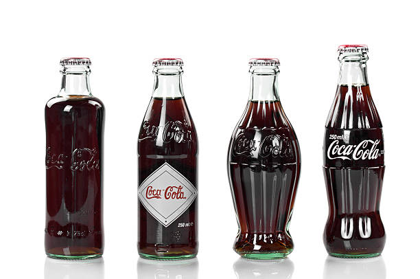 Coca-Cola Anniversary Vintage Collection Alanya, Turkey - October 10, 2011: Four Coca-Cola bottles, an 125 years old anniversary edition, studio shot. coke coal stock pictures, royalty-free photos & images