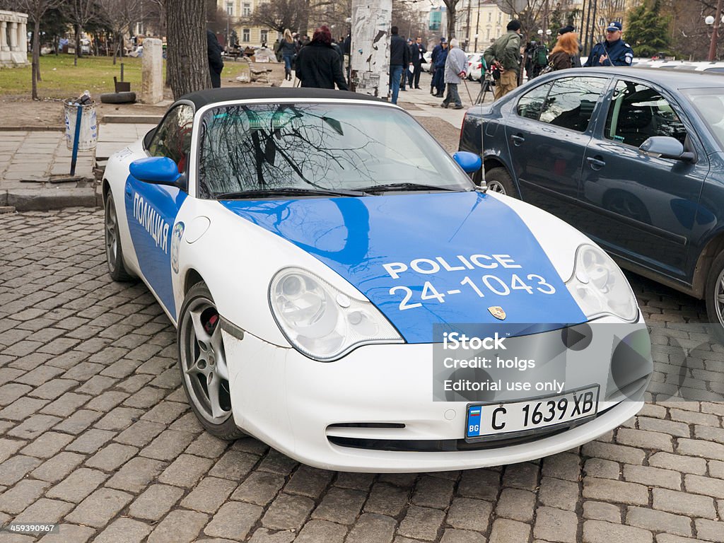 Porsche Police car in Sofia, Bulgaria Sofia, Bulgaria - March 7, 2008: Porsche Police car in Sofia, Bulgaria. A policeman and some people can be seen in the background of the image. Accidents and Disasters Stock Photo