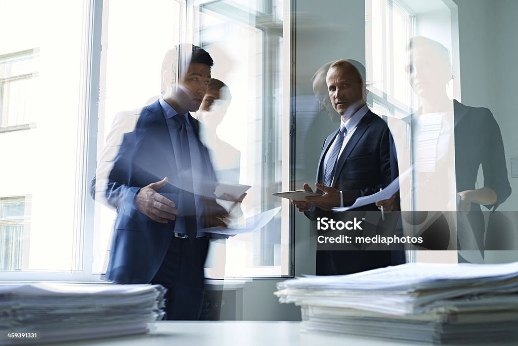 Busy business day Business people working with documents in office Blurred Motion Stock Photo