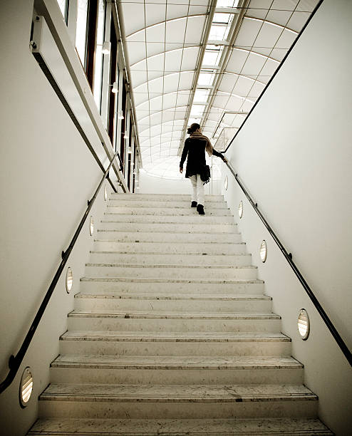 istock Woman going up staircase. 459392313
